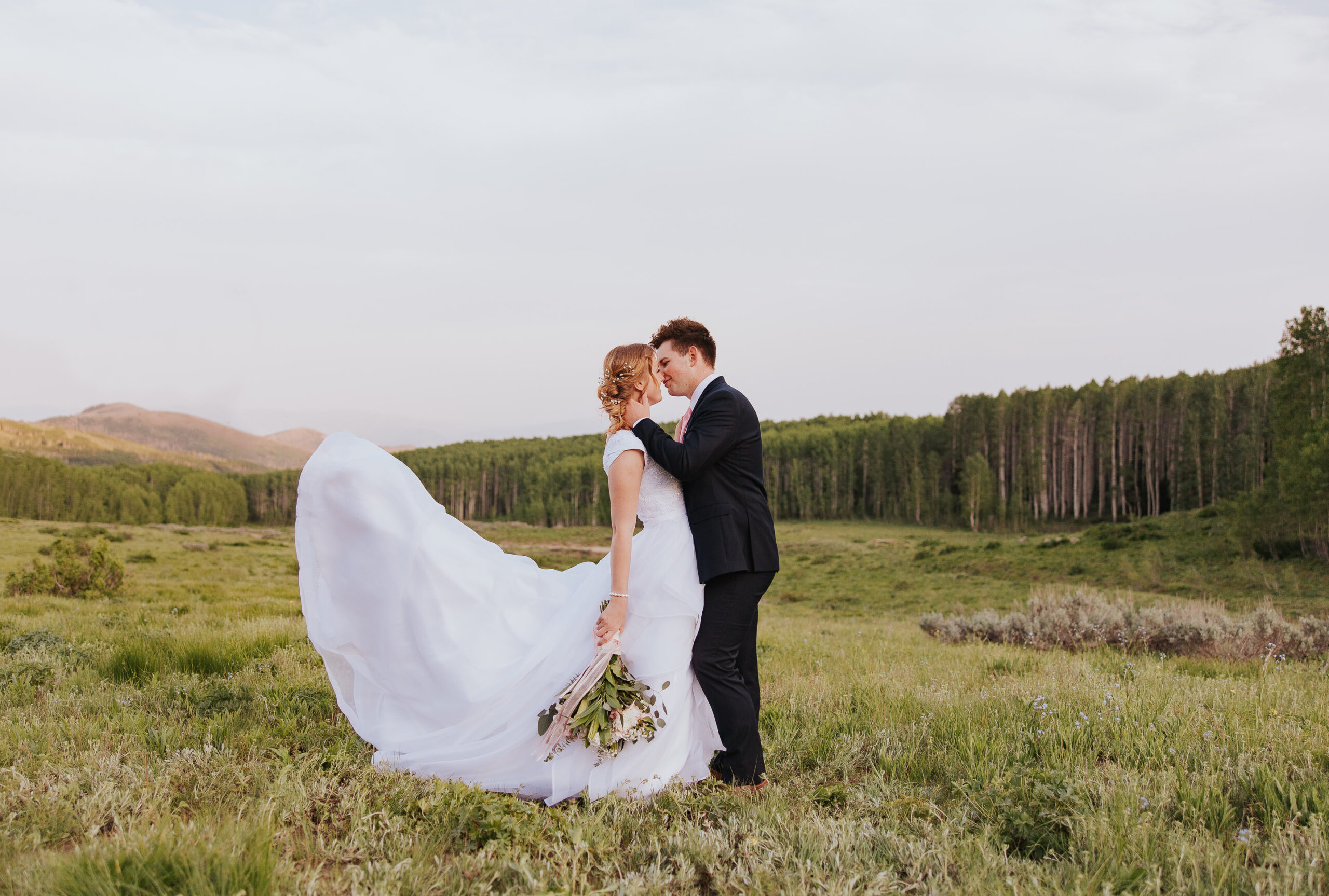 Utah wedding ceremony in green field with trees