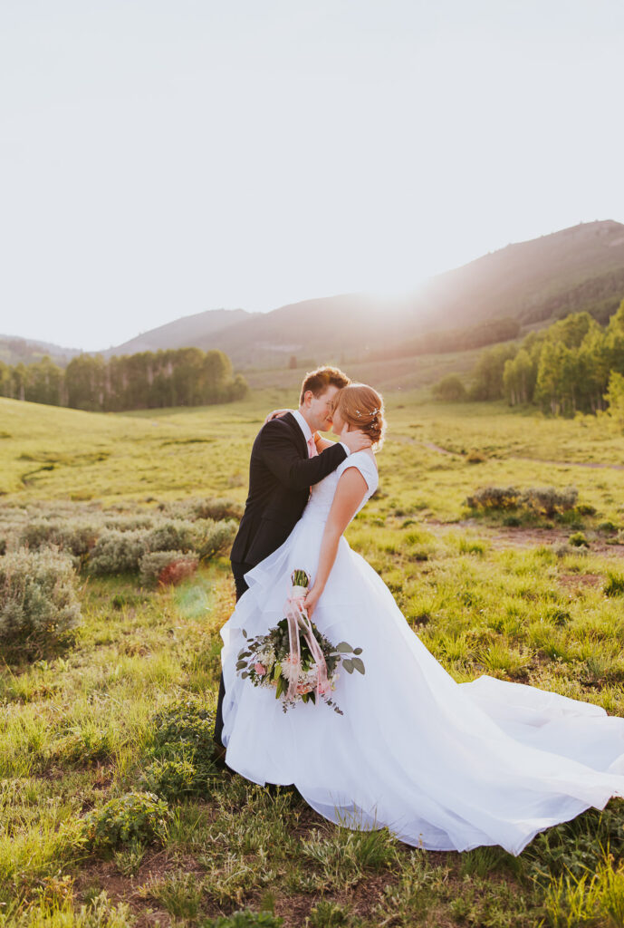 Groom dips bride before Utah wedding