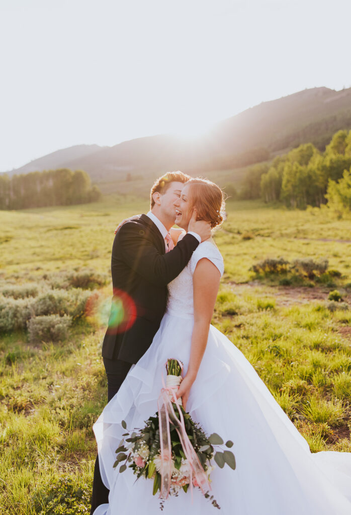 Sun flare over bride and groom during Utah wedding