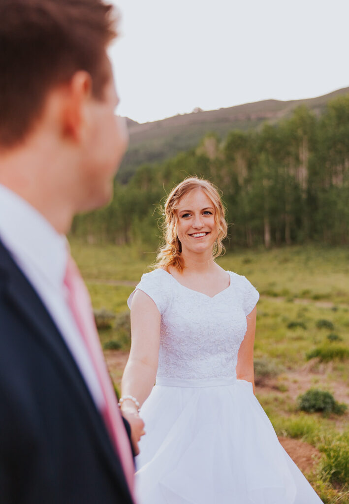 Bride smiles at groom before Utah wedding
