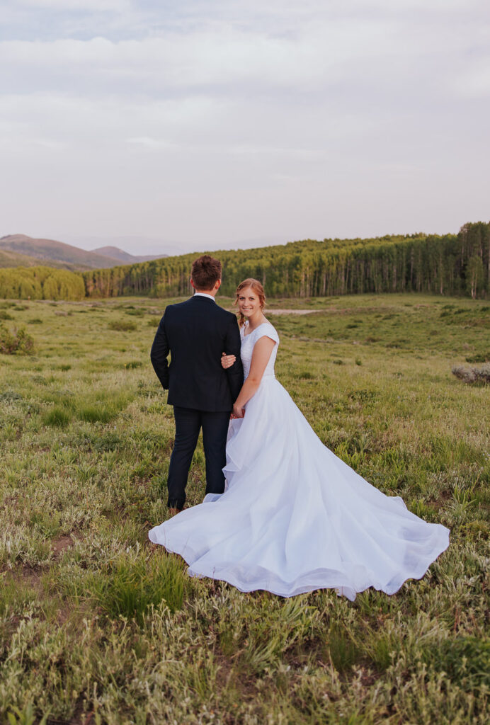 Utah wedding dress in green field near Park City Utah