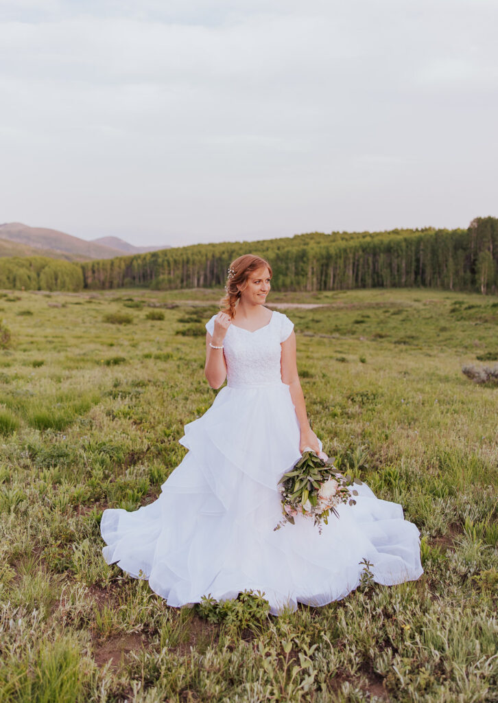Bridal hair and dress is shown in Utah field