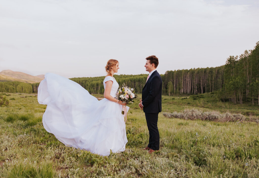 Flowing wedding dress in green Utah field