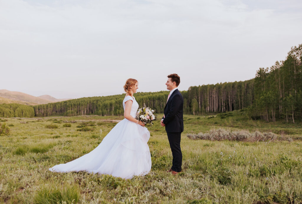 Wedding dress with long train in Utah mountains
