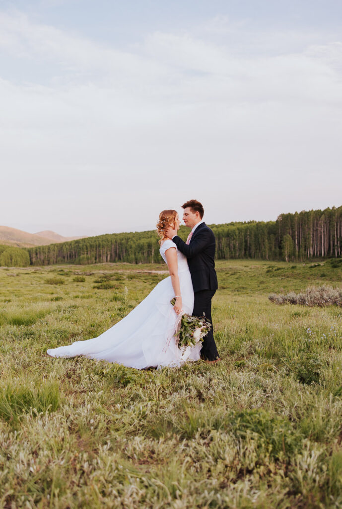 White bouquet and wedding dress with long train