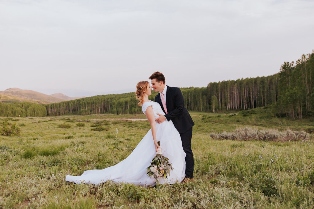 Groom dips bride in Utah mountains