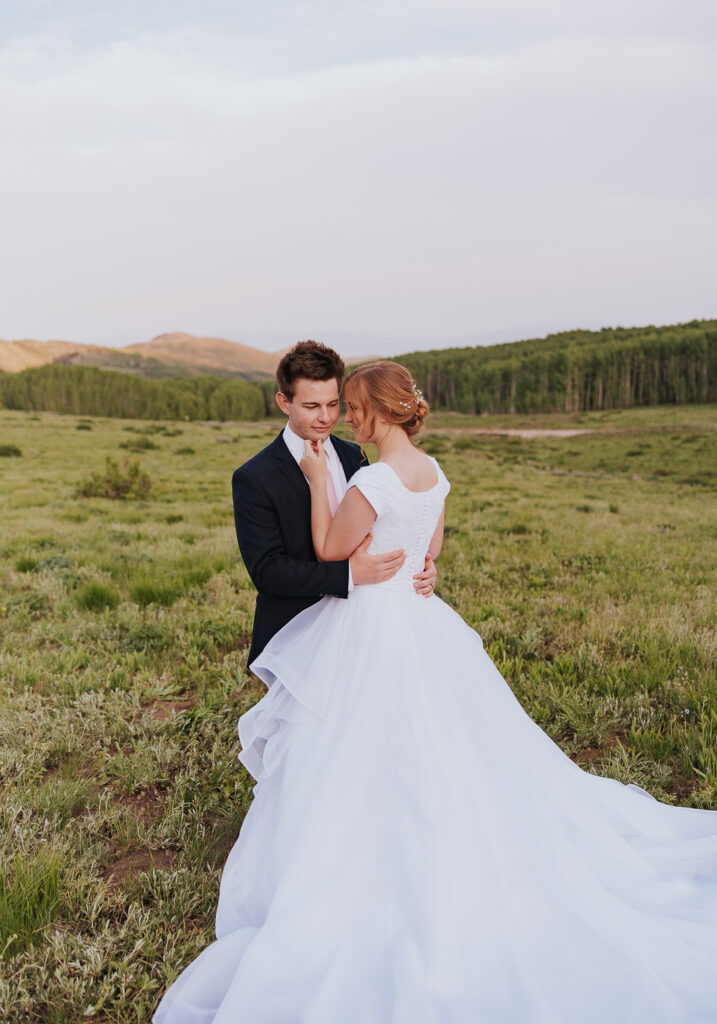 Utah wedding pose to show detail of bride's dress