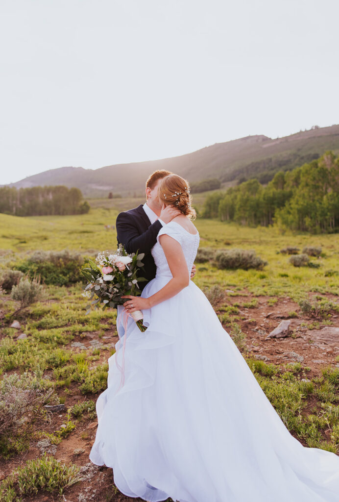 Groom kisses bride at Guardsman's Pass in Park City