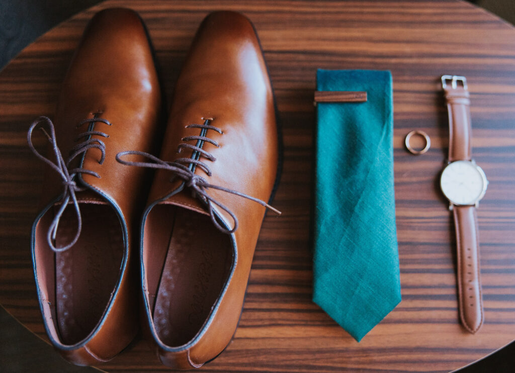 Details of groom's shoes, tie, ring, and watch