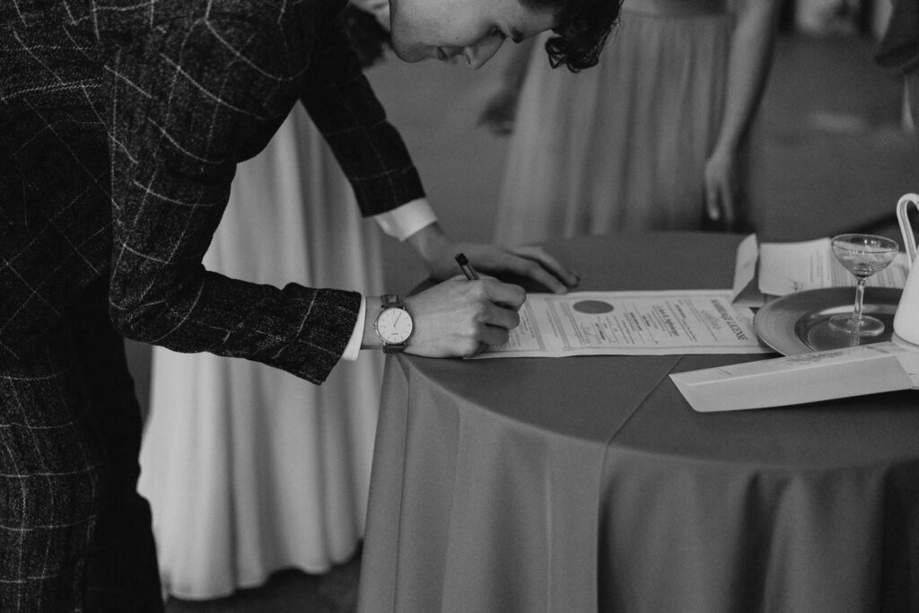 Groom signs marriage license in Toledo, Ohio