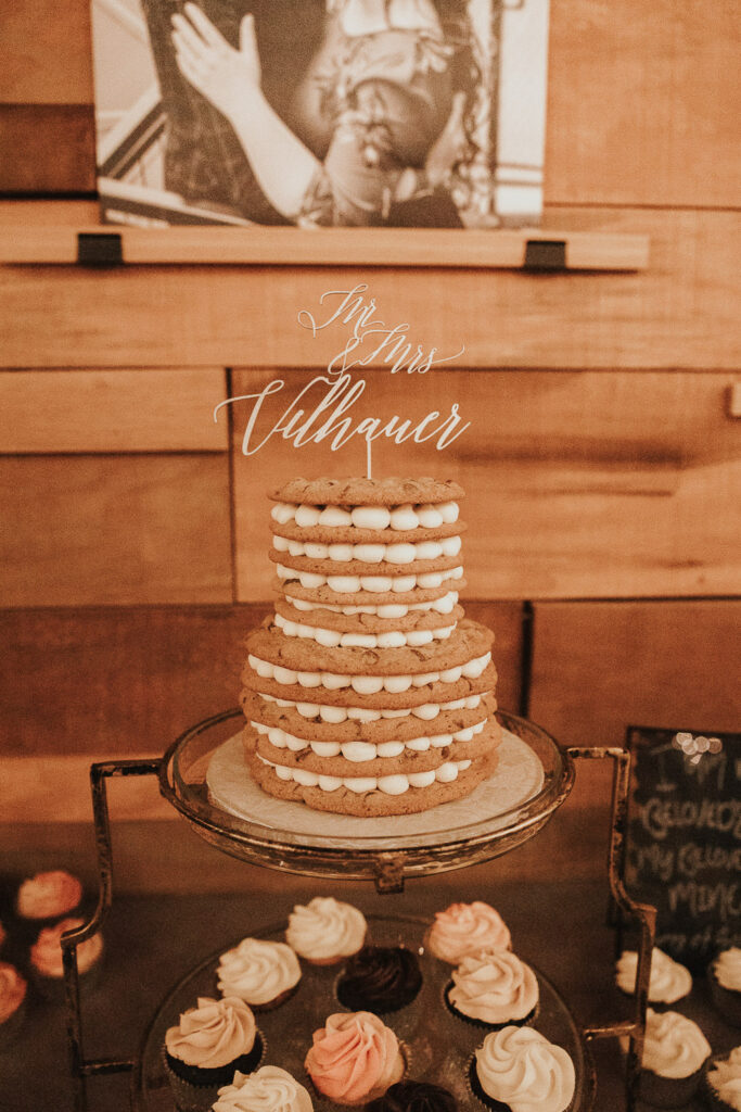 Wedding cake made of cookies and frosting with wooden cake topper