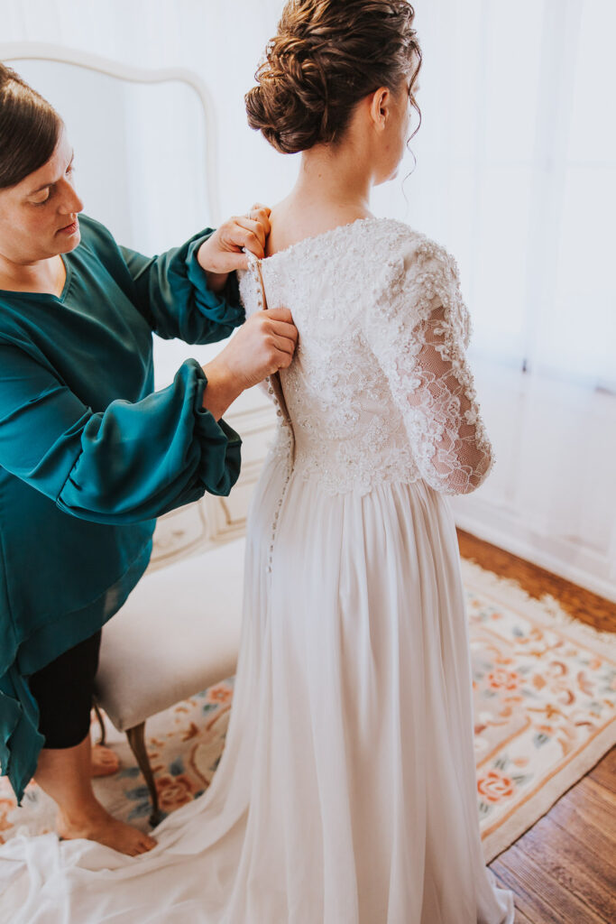 Mother of the bride helps daughter get ready in Toledo Ohio