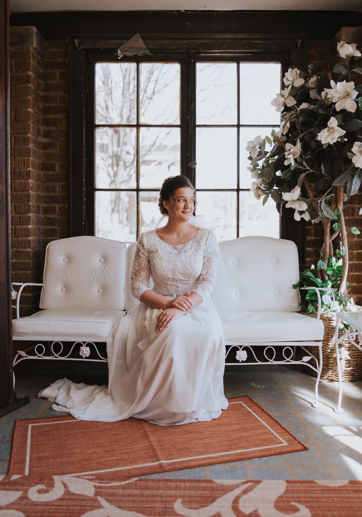 Bride sits in beautiful lighting before her wedding day