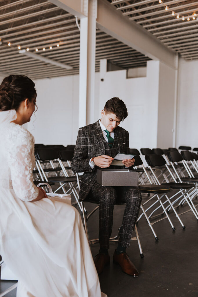 Groom opens gift from bride before wedding