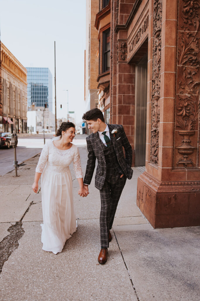 Bride and groom walk downtown in Toledo, Ohio