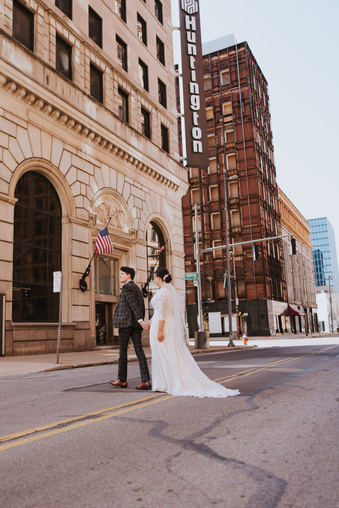 Bride and groom walk across the street for industrial downtown wedding