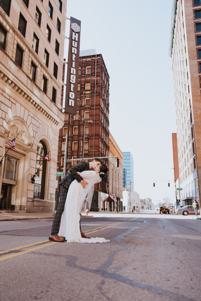 Bride and groom embrace in street for industrial downtown wedding